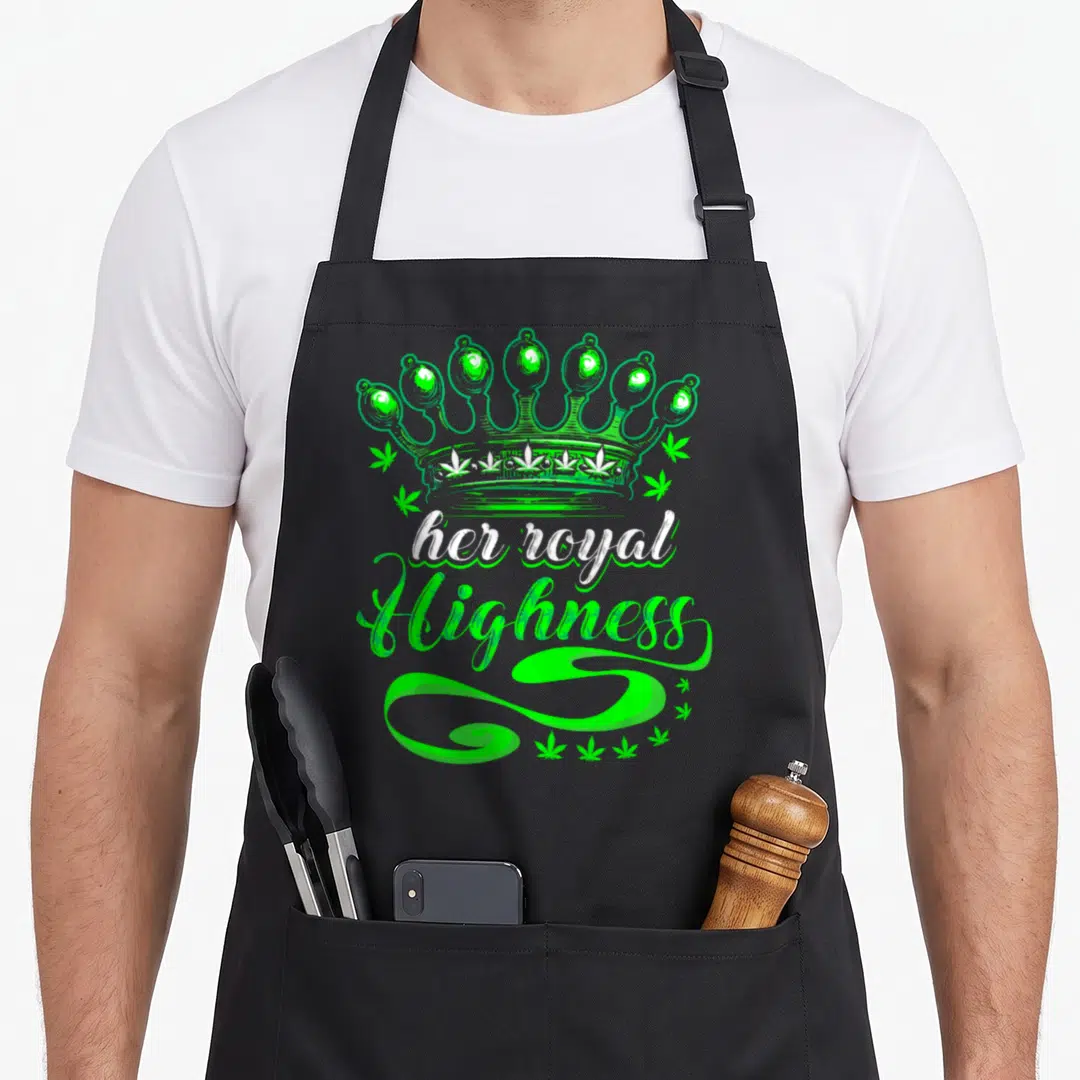 Pot smoking apron - Green crown with white her royal Highness text and scattered cannabis leaves on black fabric — shown on a black cotton canvas apron against a white background