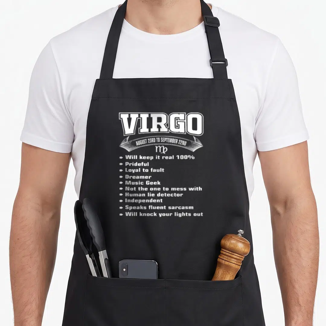 Virgo fact zodiac aprons - White Virgo text listing traits like Music Geek and speaks fluent sarcasm with arrow bullets — shown on a black cotton canvas apron against a white background