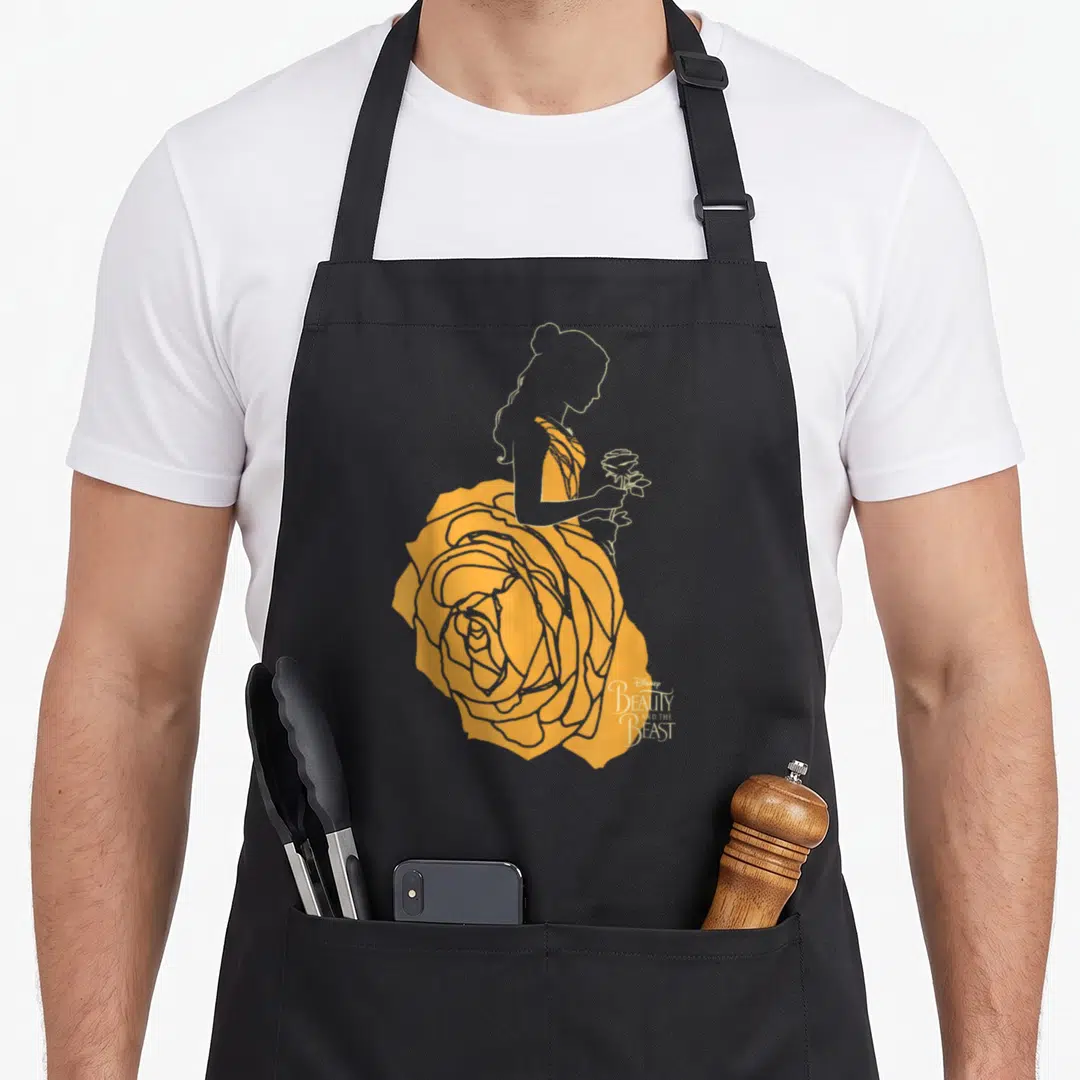Beast rose apron - Woman silhouette in yellow rose dress holding flower with Beauty and the Beast text — shown on a black cotton canvas apron against a white background