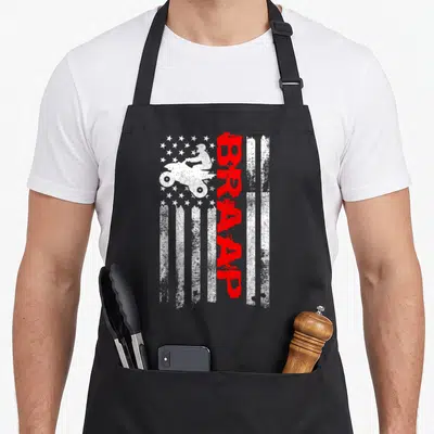 Wheeler american flag apron - Distressed white flag with quad bike silhouette and vertical red BRAAP text — shown on a black cotton canvas apron against a white background