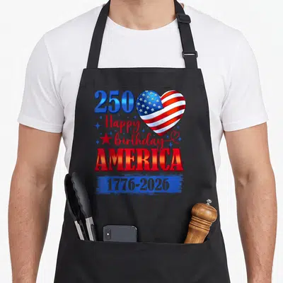Vintage 250th 4th of july apron - 250 Happy birthday AMERICA text with flag heart and 1776-2026 dates in red white blue — shown on a black cotton canvas apron against a white background