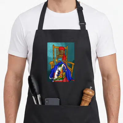 Ayiti haitian apron - Woman in red headwrap holds Haitian flag with union fait la force text in cartoon style — shown on a black cotton canvas apron against a white background