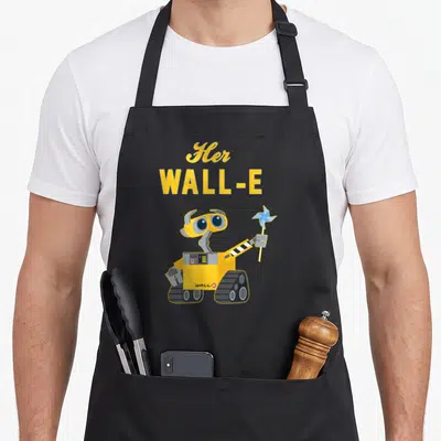 Wall couple apron - Yellow WALL-E robot holding blue pinwheel under stacked yellow text reading Her WALL-E — shown on a black cotton canvas apron against a white background