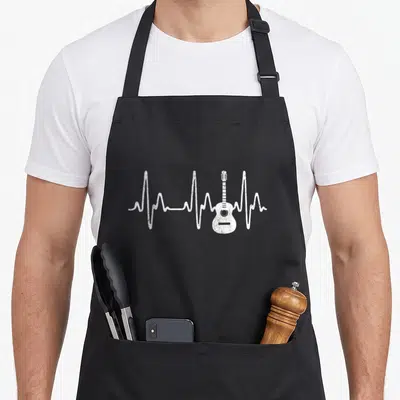 Heartbeat acoustics apron - White distressed acoustic guitar inside a white EKG heartbeat line on grey background — shown on a black cotton canvas apron against a white background