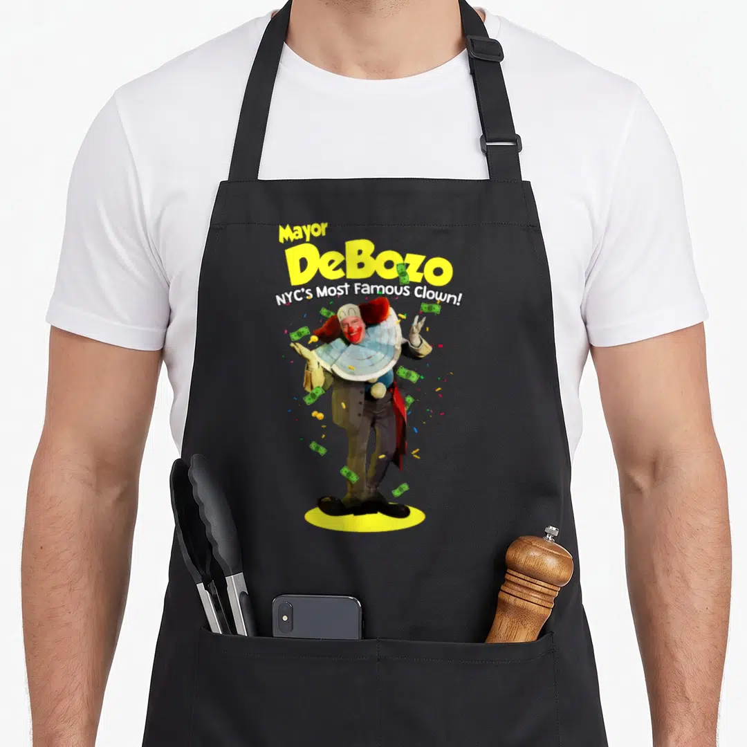 Mayor clown aprons - Clown standing on yellow oval with money confetti and Mayor DeBozo text — shown on a black cotton canvas apron against a white background