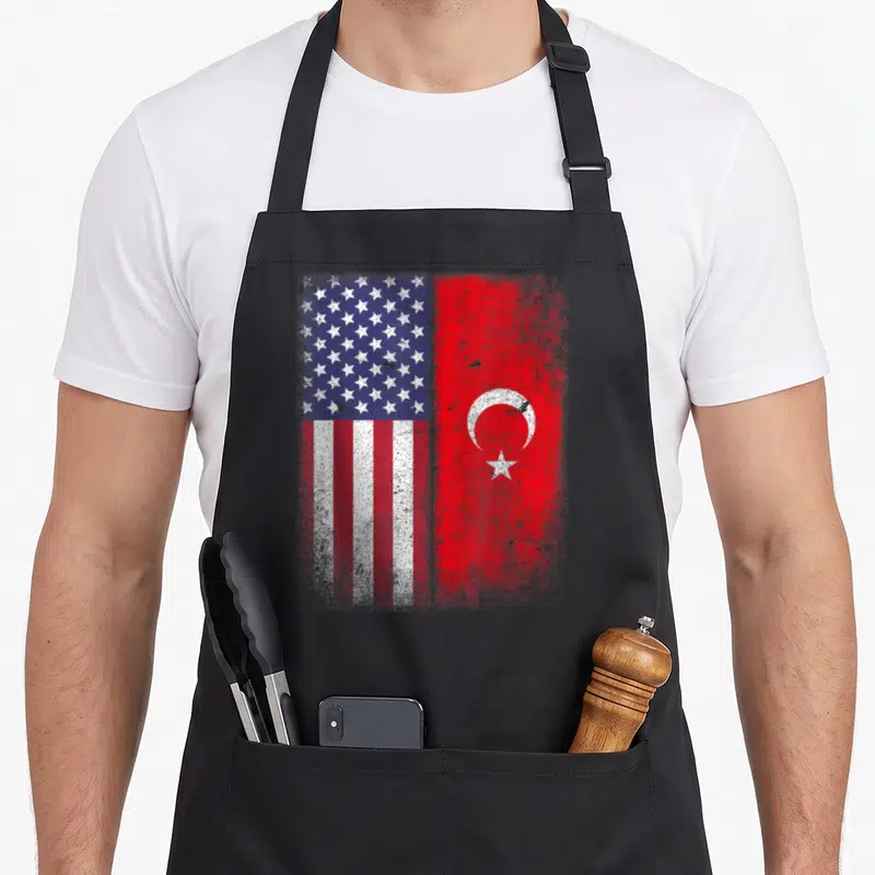 Turkey american flag apron - Distressed USA and Turkey flags side by side in red white blue — shown on a black cotton canvas apron against a white background