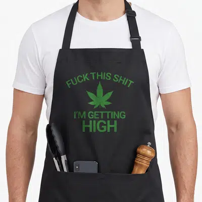 Marijuana funny hemp apron - Green distressed cannabis leaf with arched text reading fuck this shit i am getting high — shown on a black cotton canvas apron against a white background