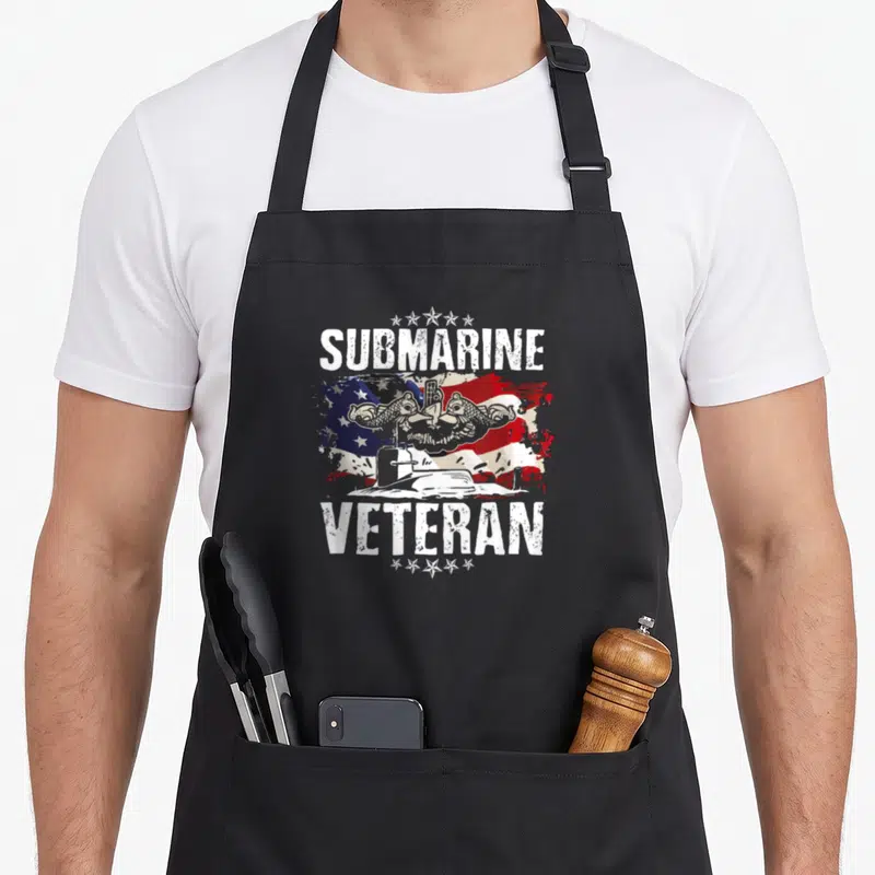Submarine veteran submariner military apron - Distressed US flag with two dolphins, submarine, and text SUBMARINE — shown on a black cotton canvas apron against a white background