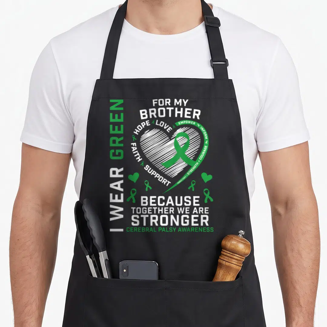 Brother cerebral palsy awareness apron - White sketched heart with green ribbon and vertical text reading I WEAR GREEN — shown on a black cotton canvas apron against a white background