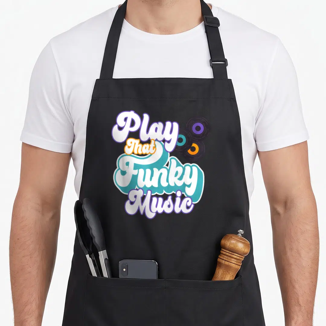 Play funky apron - Stacked retro script reading Play That Funky Music beside three colored vinyl records — shown on a black cotton canvas apron against a white background