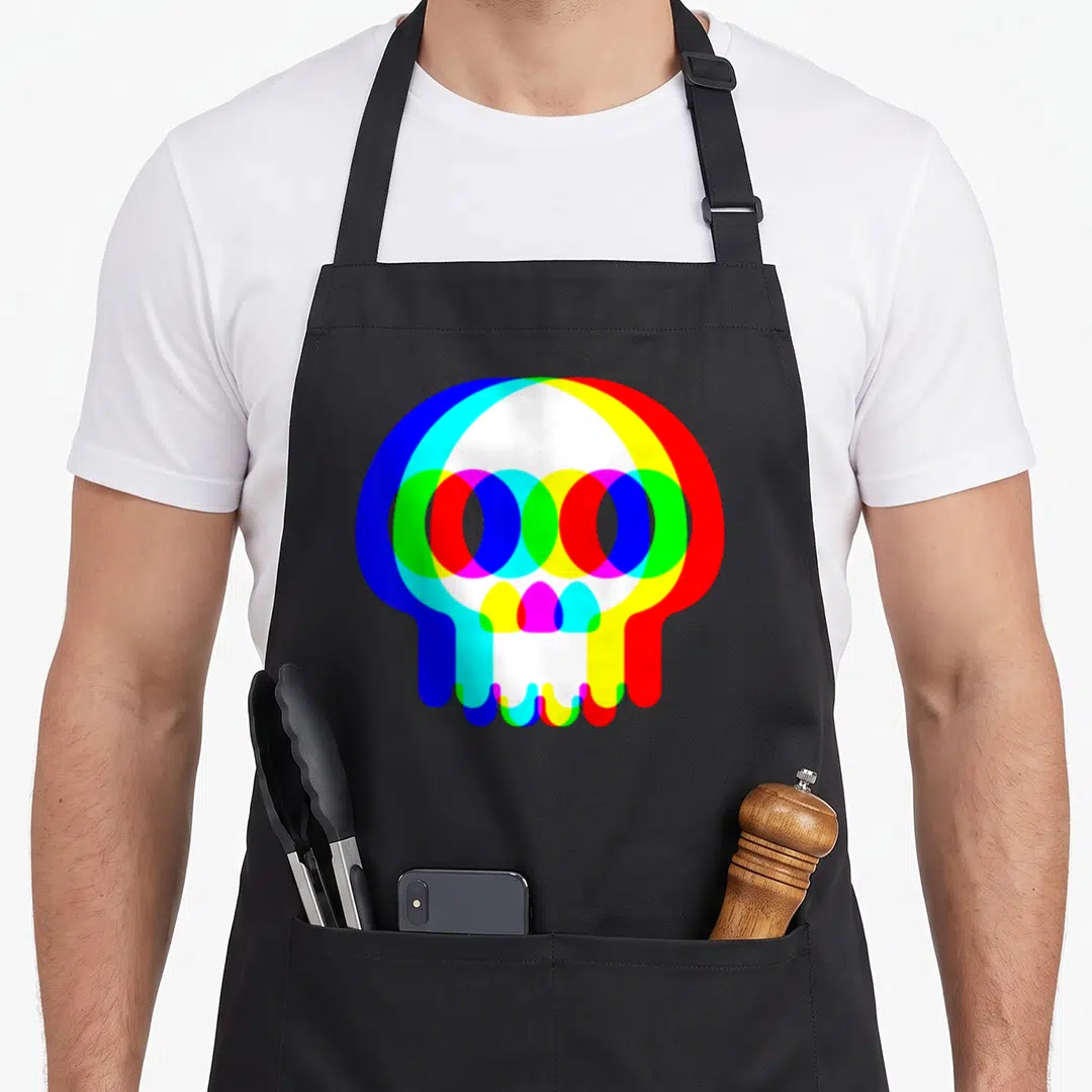 Techno halloween apron - Minimalist skull formed by overlapping translucent blue, red, yellow, green, magenta, cyan — shown on a black cotton canvas apron against a white background