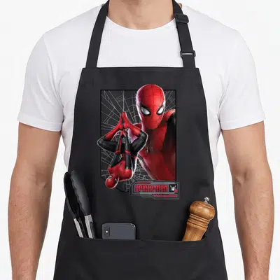 Suit novelty apron - Spider-Man face portrait behind hanging figure with SPIDER-MAN logo in red black white — shown on a black cotton canvas apron against a white background