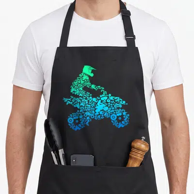 Quad biker apron - Motocross rider silhouette formed by green and blue mechanical tools and gears — shown on a black cotton canvas apron against a white background