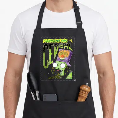 Invader cereal apron - Green monster wearing purple cereal box with I LOOOOVE THIS text and ray gun — shown on a black cotton canvas apron against a white background