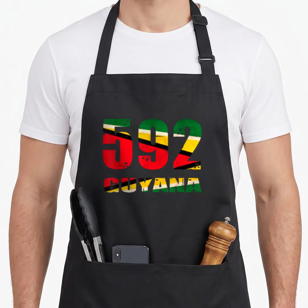 Guyana guyanese apron - 592 and GUYANA text filled with green yellow red black and white flag pattern in distressed — shown on a black cotton canvas apron against a white background