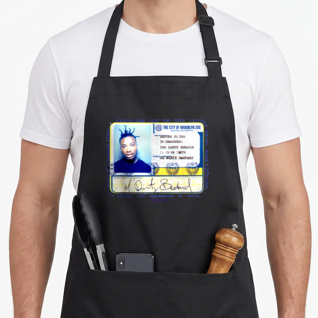 Ard the dirty apron - Ol Dirty Bastard Brooklyn Zoo ID card with food coupon text and yellow blue white colors — shown on a black cotton canvas apron against a white background