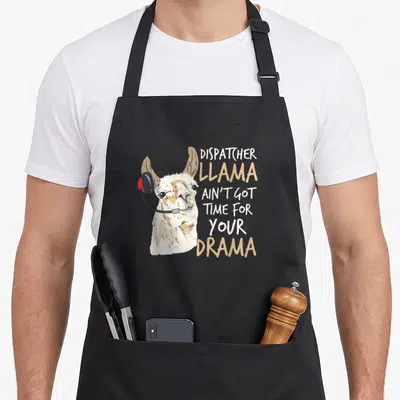 Operator dispatcher apron - Cartoon llama wearing red headset next to stacked text DISPATCHER LLAMA AIN'T GOT TIME — shown on a black cotton canvas apron against a white background