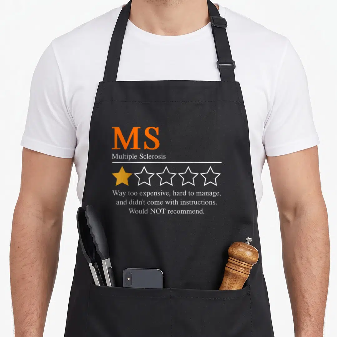 Recommend multiple sclerosis awareness apron - Orange MS text above one filled star and white review quote on black — shown on a black cotton canvas apron against a white background