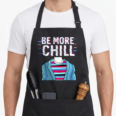 Chill couch apron - Glitch text Be More Chill above headless person in striped shirt and blue jacket — shown on a black cotton canvas apron against a white background