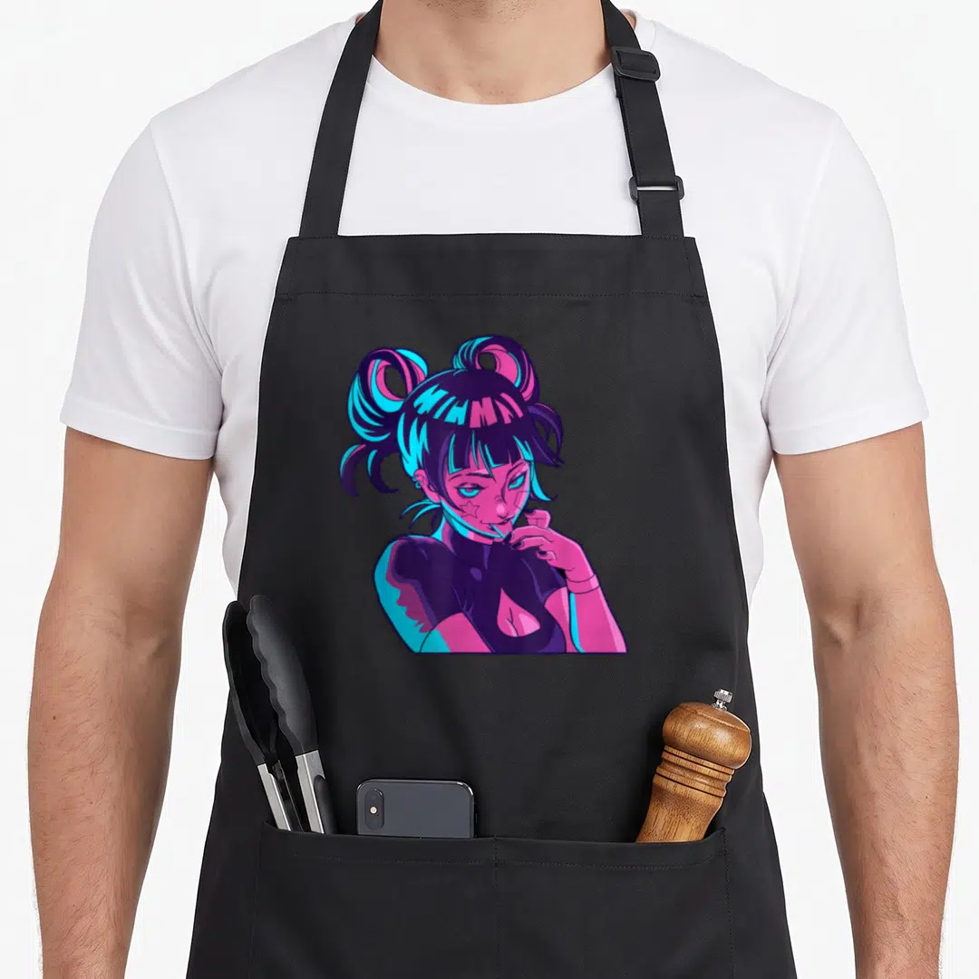 Indie goth apron - Cartoon woman with twin buns, pink and blue skin, star on cheek, high collar shirt — shown on a black cotton canvas apron against a white background