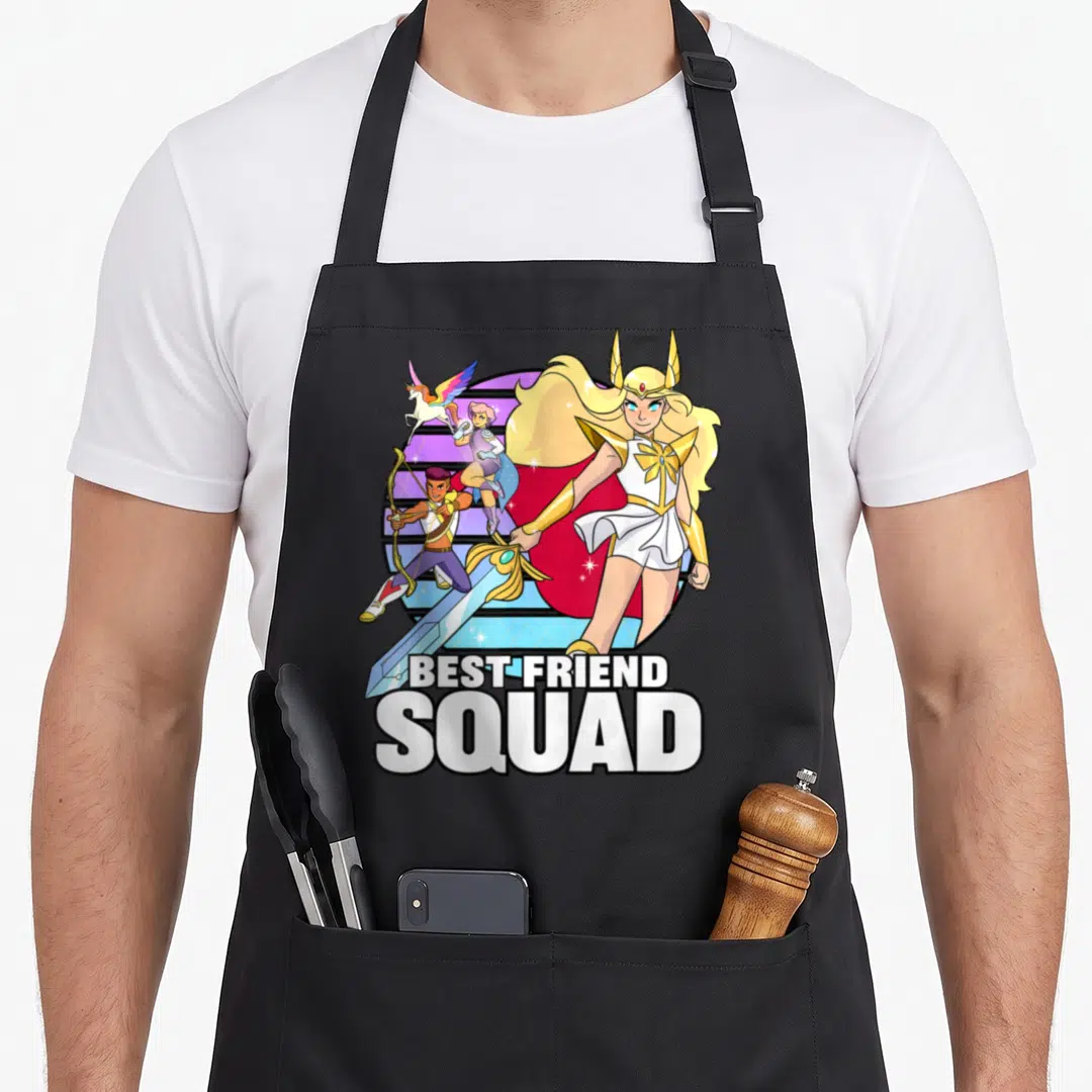 Friend princess apron - She-Ra, Bow, Glimmer, and unicorn with stacked BEST FRIEND SQUAD text — shown on a black cotton canvas apron against a white background
