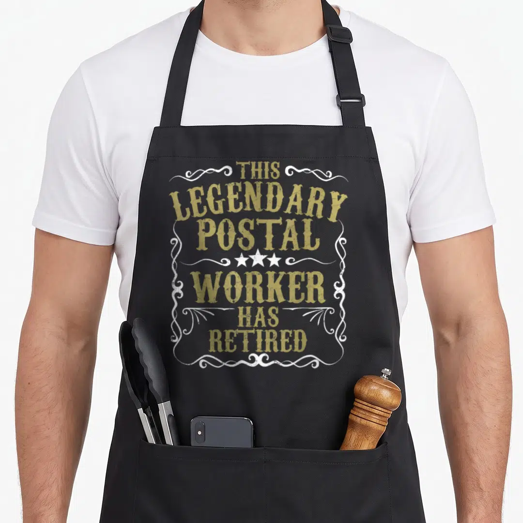 Legendary retirement apron - Gold distressed text reading THIS LEGENDARY POSTAL WORKER HAS RETIRED inside a white — shown on a black cotton canvas apron against a white background