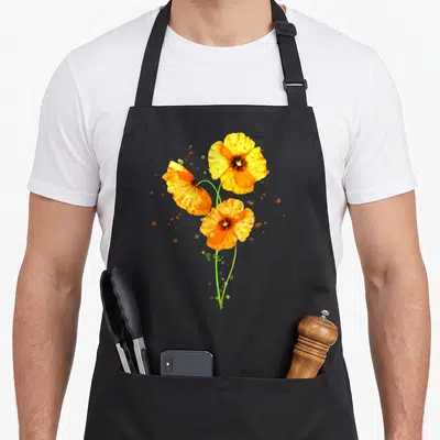 Poppy orange california apron - Three orange and yellow watercolor poppies on green stems with scattered paint splatters — shown on a black cotton canvas apron against a white background
