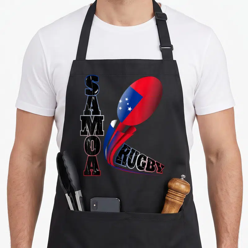 Samoa distressed apron - Vertical SAMOA text beside flag-patterned rugby ball with red blue black white swoosh leading — shown on a black cotton canvas apron against a white background