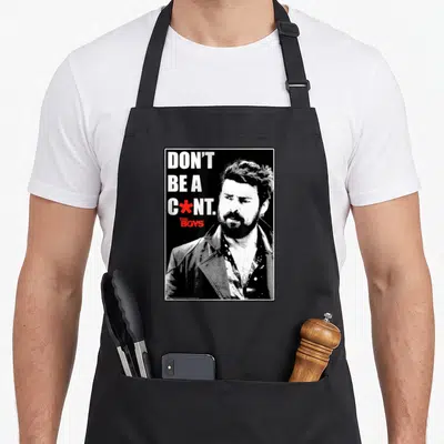Superhero butcher apron - Black and white male portrait with bold text and a red star replacing a letter — shown on a black cotton canvas apron against a white background