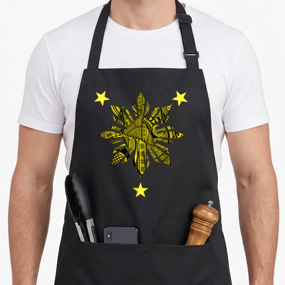 Filipino tattoo apron - Yellow and black tribal leaf pattern with three yellow stars in line art — shown on a black cotton canvas apron against a white background