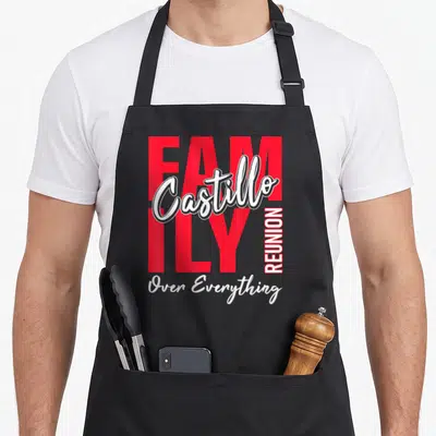 Castillo gathering apron - Red and white typography reading FAMILY Castillo REUNION Over Everything on a black — shown on a black cotton canvas apron against a white background