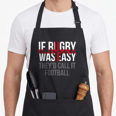 English england rugby apron - Stacked white red grey text IF RUGBY WAS EASY THEY'D CALL IT FOOTBALL — shown on a black cotton canvas apron against a white background