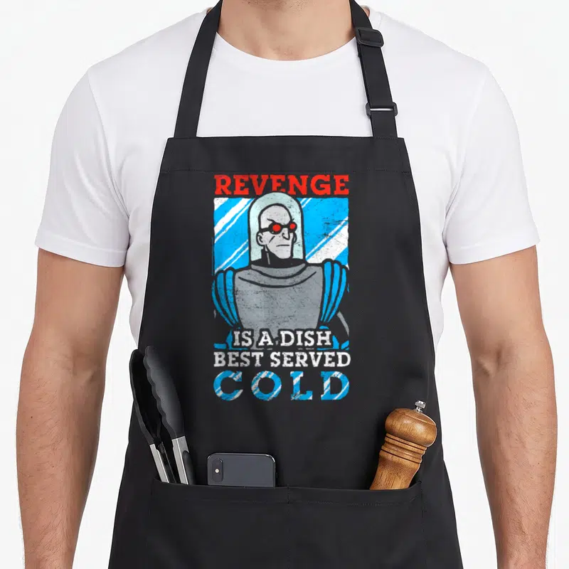 Animated mr apron - Villain portrait with REVENGE IS A DISH BEST SERVED COLD text in distressed red and blue stripes — shown on a black cotton canvas apron against a white background