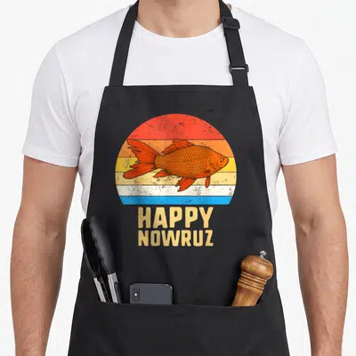 Nowruz iran apron - Retro orange goldfish over striped sunset circle with HAPPY NOWRUZ text below — shown on a black cotton canvas apron against a white background