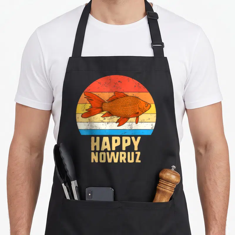 Nowruz iran apron - Retro orange goldfish over striped sunset circle with HAPPY NOWRUZ text below — shown on a black cotton canvas apron against a white background