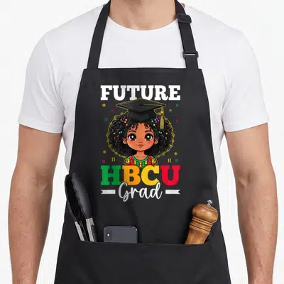Future african american aprons - Cartoon girl in cap with FUTURE HBCU Grad text and geometric shapes — shown on a black cotton canvas apron against a white background