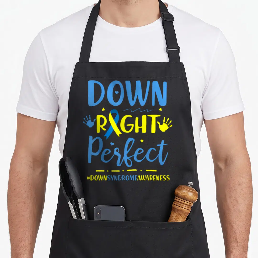 Parent down syndrome awareness apron - Down Right Perfect text with blue yellow ribbon, handprints and stars — shown on a black cotton canvas apron against a white background
