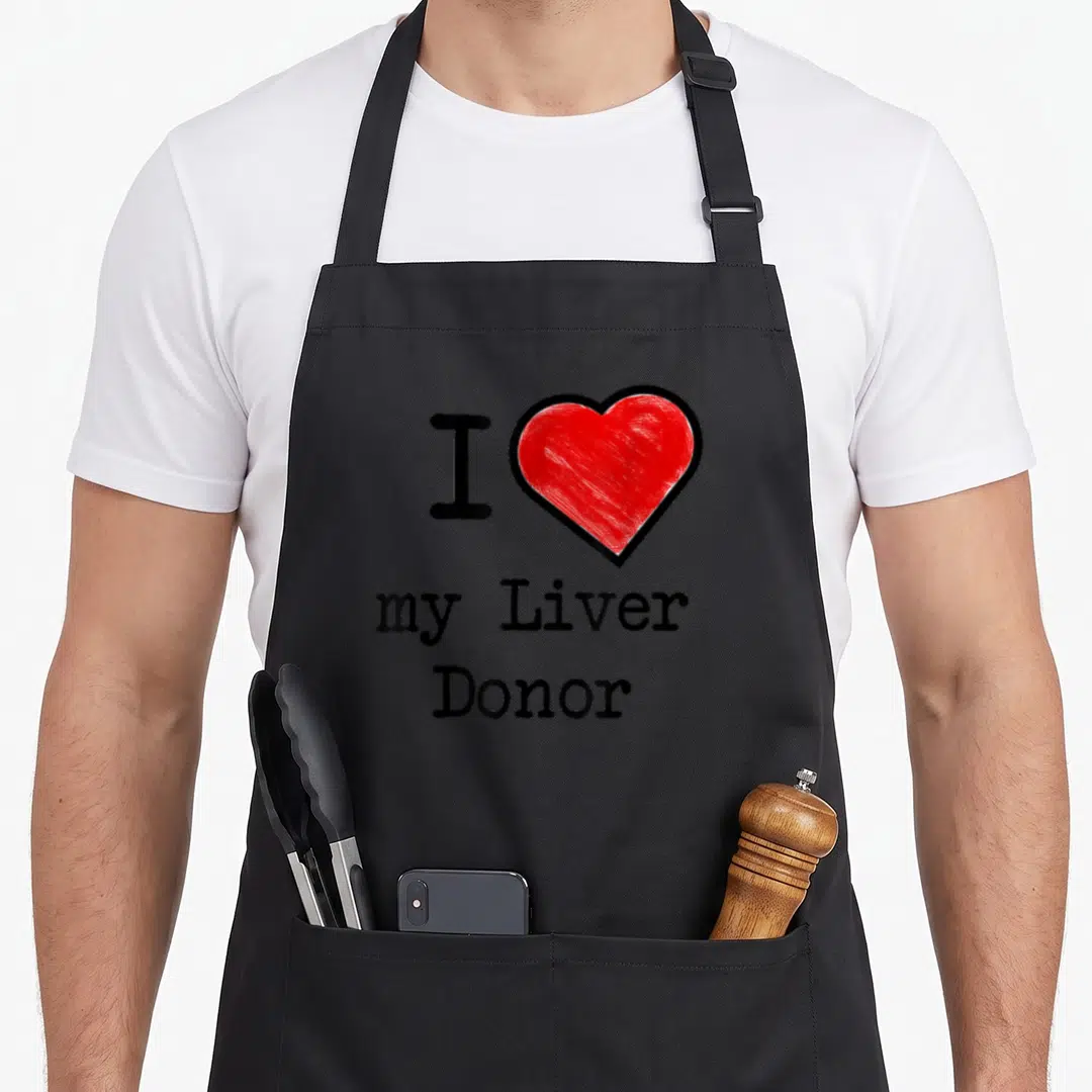 Liver donor organ apron - Red sketched heart next to I my Liver Donor text — shown on a black cotton canvas apron against a white background
