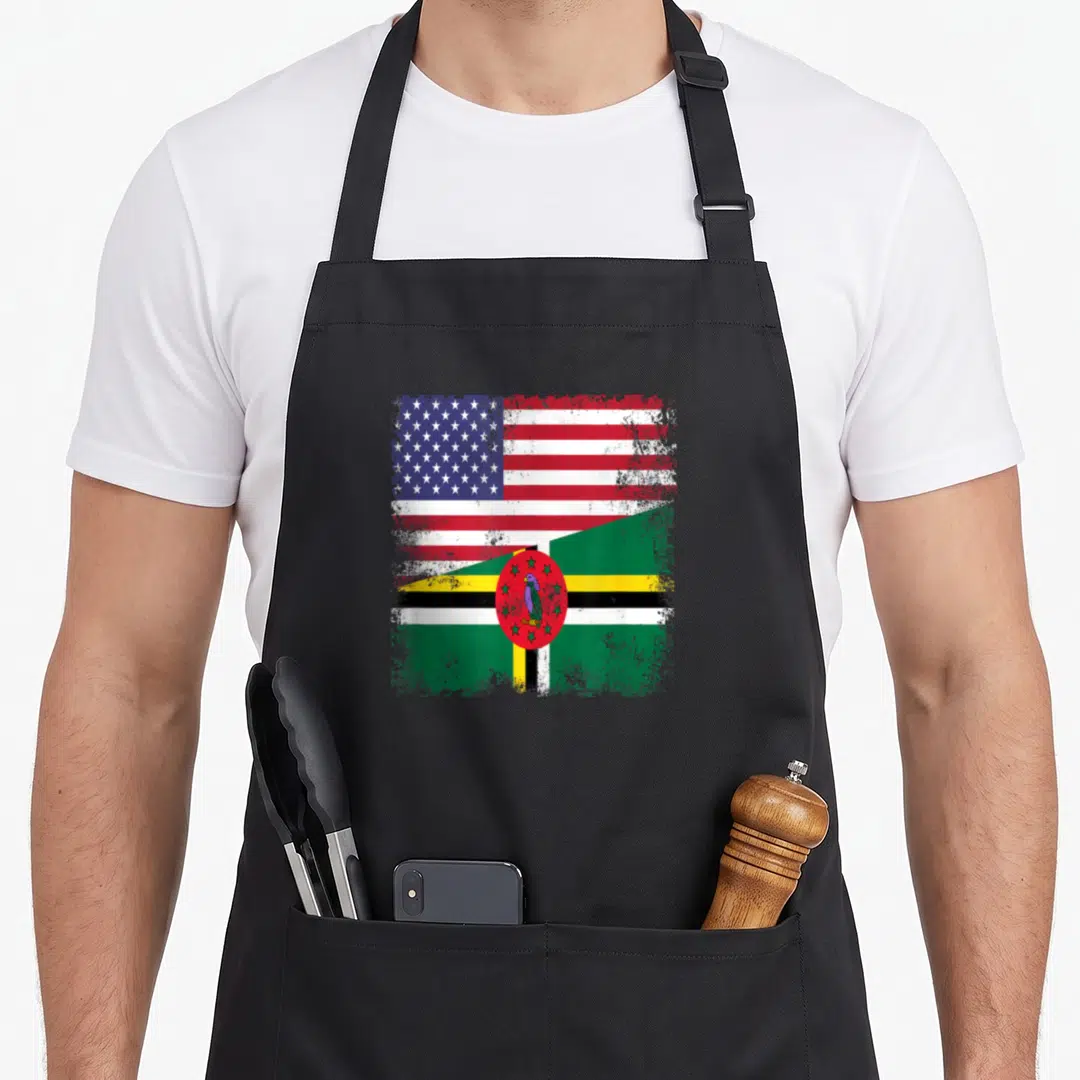 Flag dominican pride apron - Distressed split US and Dominica flag design with parrot emblem in red white blue green — shown on a black cotton canvas apron against a white background
