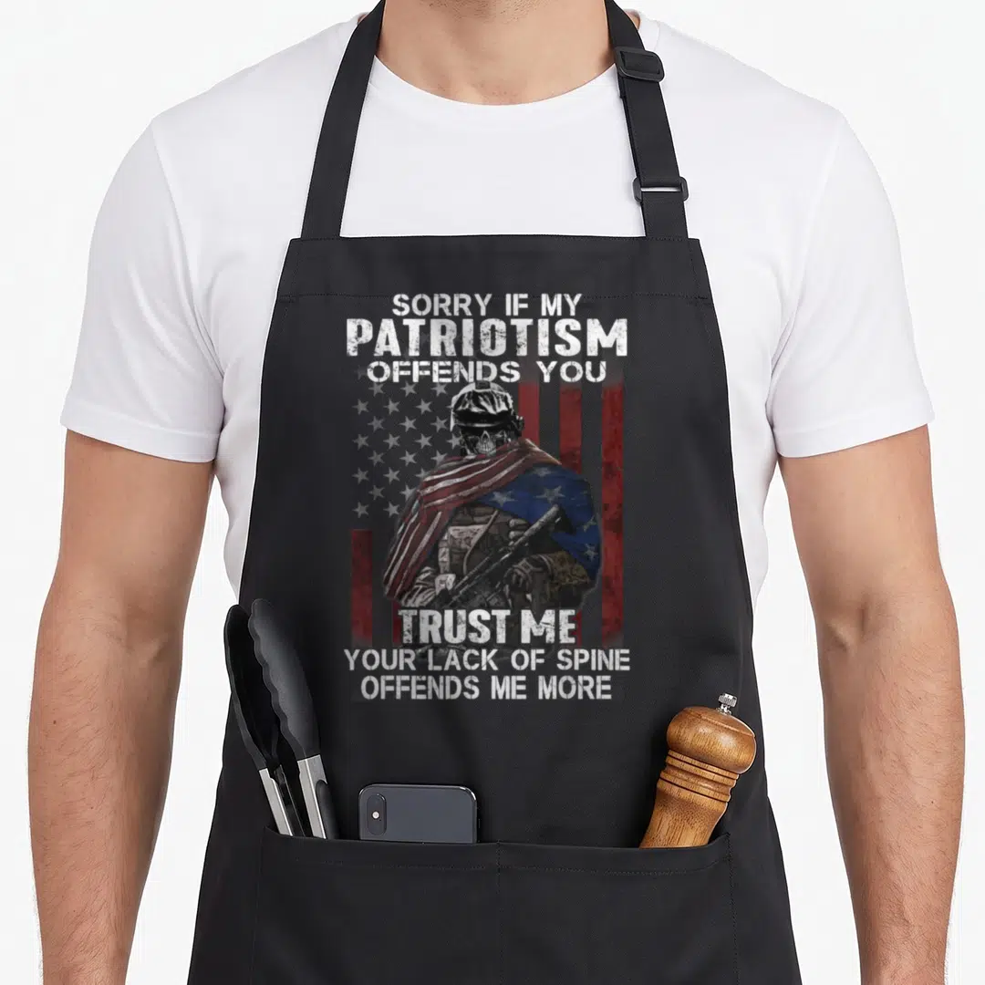 Sorry veteran humor apron - Distressed skull soldier draped in US flag holding rifle with patriotic text — shown on a black cotton canvas apron against a white background