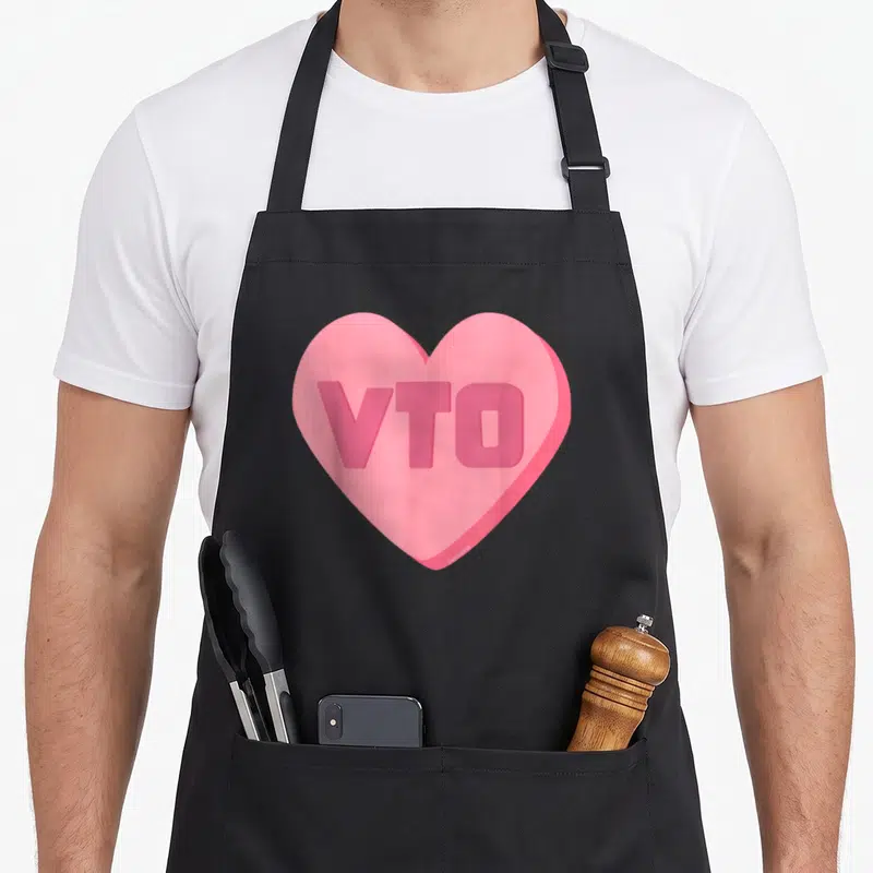 Vto valentine's day apron - Pink 3D heart with VTO text centered inside — shown on a black cotton canvas apron against a white background