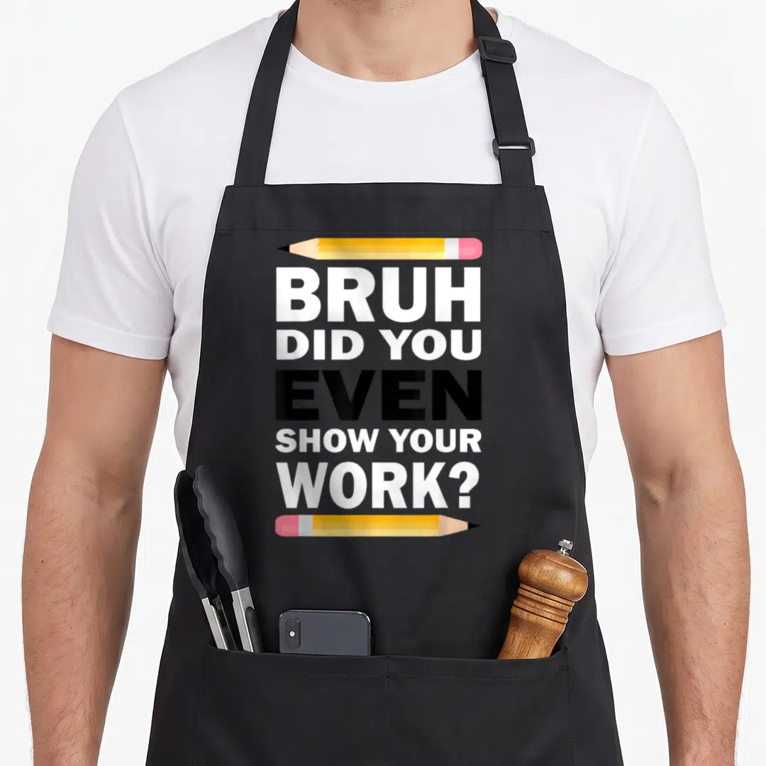 Bruh teacher apron - Stacked text reading BRUH DID YOU EVEN SHOW YOUR WORK framed by horizontal yellow pencils — shown on a black cotton canvas apron against a white background