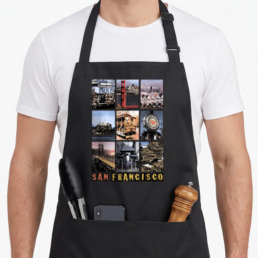 Cali san francisco apron - 3x3 grid of San Francisco landmark photos with Pier 39 sign and bold SAN FRANCISCO text below — shown on a black cotton canvas apron against a white background
