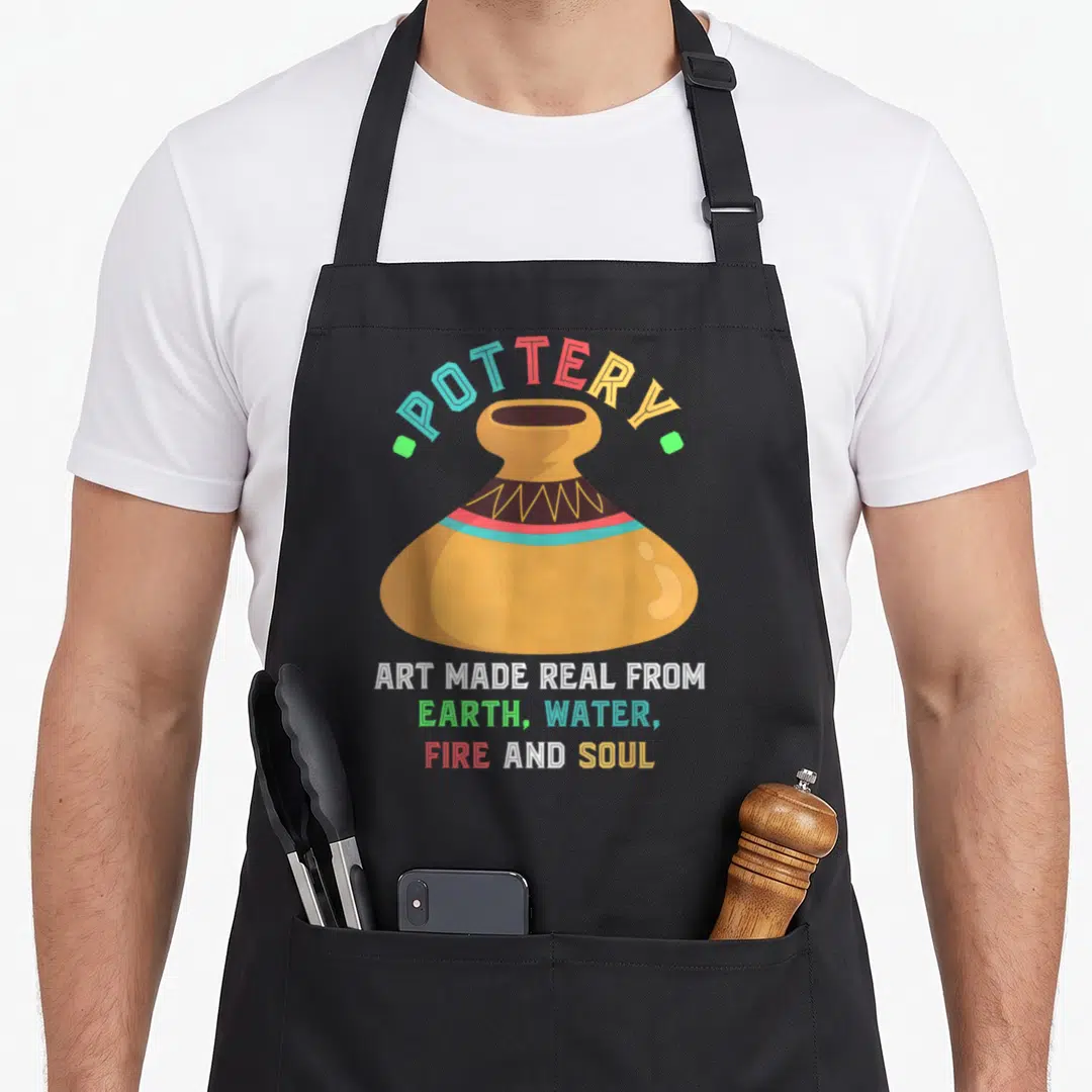 Earth ceramic apron - Tan vase with arched POTTERY text and stacked quote about earth water fire and soul — shown on a black cotton canvas apron against a white background
