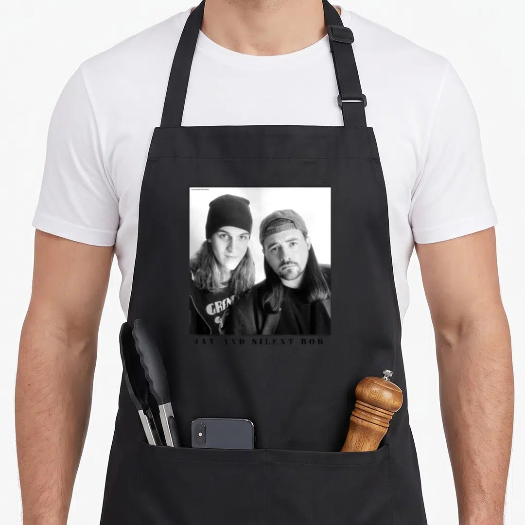 Jay simple apron - Black and white photo of two men with JAY AND SILENT BOB text below — shown on a black cotton canvas apron against a white background