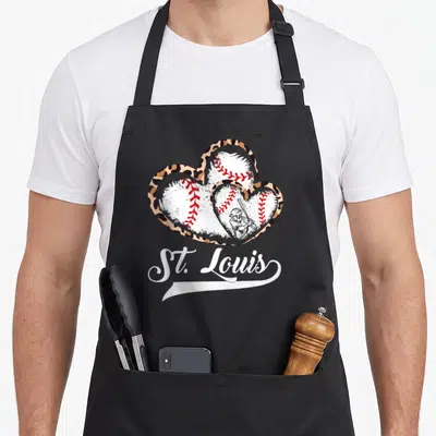Louis st apron - Three leopard hearts with baseballs and St. Louis script — shown on a black cotton canvas apron against a white background