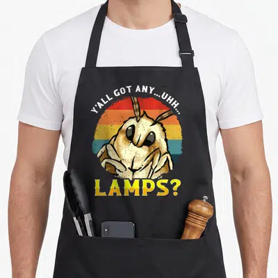 Uhh meme apron - Cartoon moth in front of red yellow and blue striped circle with text asking about lamps — shown on a black cotton canvas apron against a white background