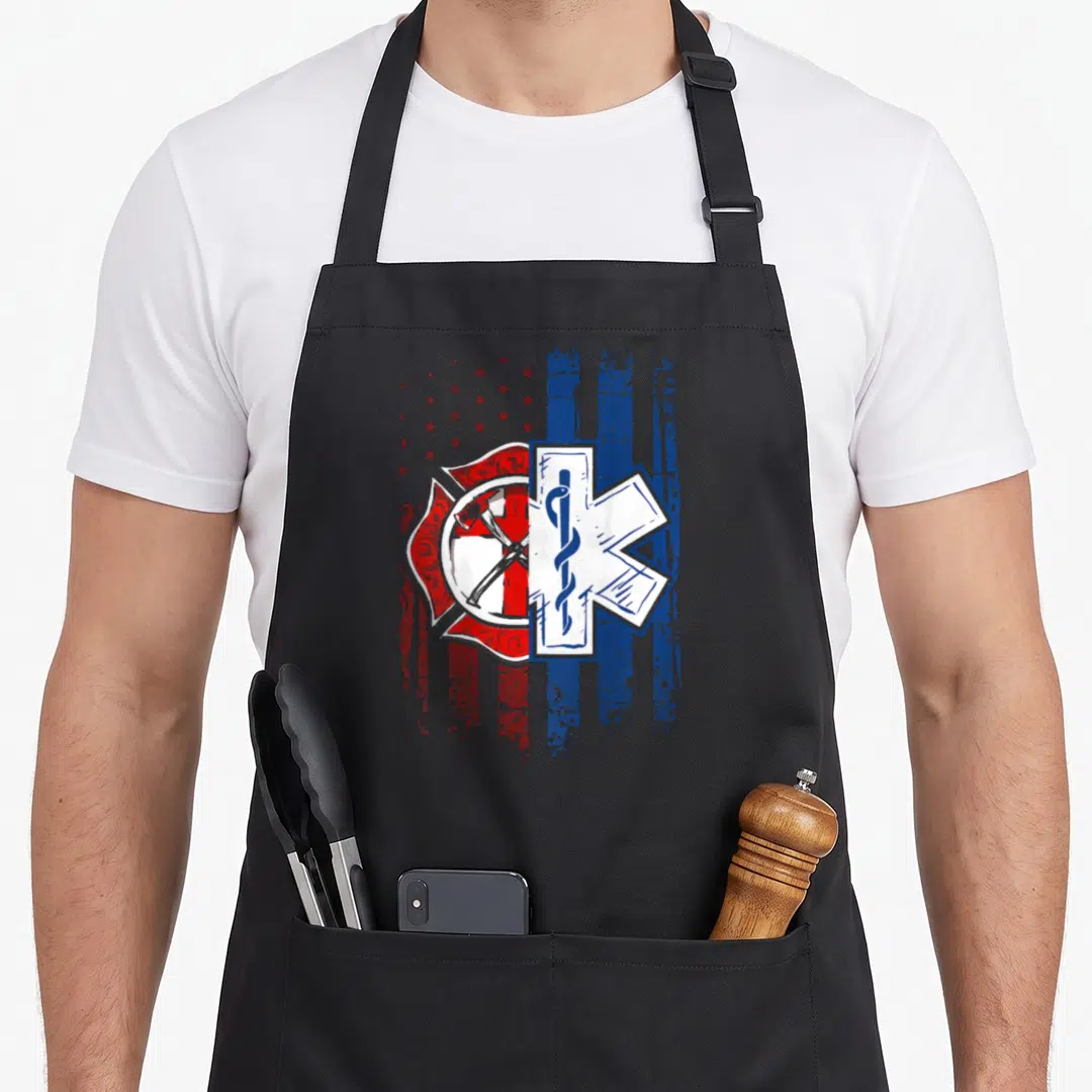 Paramedic patriotic apron - Split Maltese cross and Star of Life over distressed red white blue flag — shown on a black cotton canvas apron against a white background