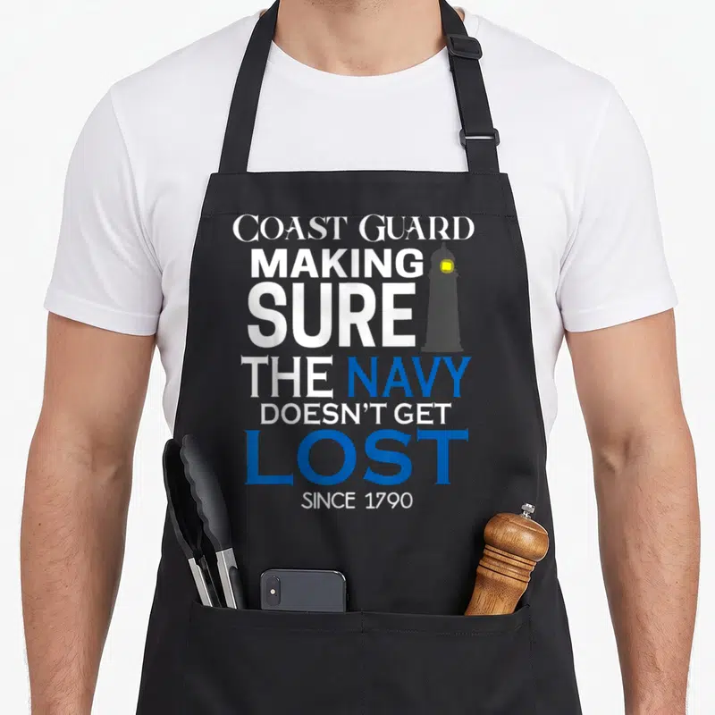 Coast making aprons - Stacked text reading Coast Guard Making Sure The Navy Doesn't Get Lost Since 1790 with a grey — shown on a black cotton canvas apron against a white background