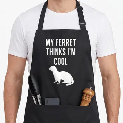 Animal i love my ferret apron - White stacked text MY FERRET THINKS I'M COOL above a sitting ferret silhouette — shown on a black cotton canvas apron against a white background